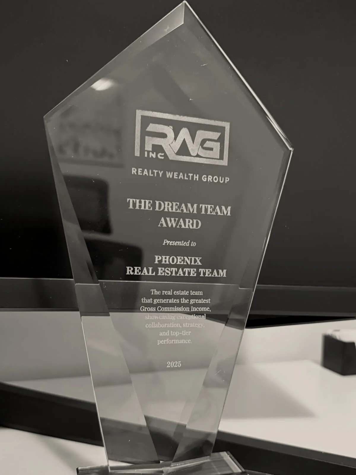 Glass trophy engraved: Realty Wealth Group, The Dream Team Award, presented to Phoenix Real Estate Team, 2025.